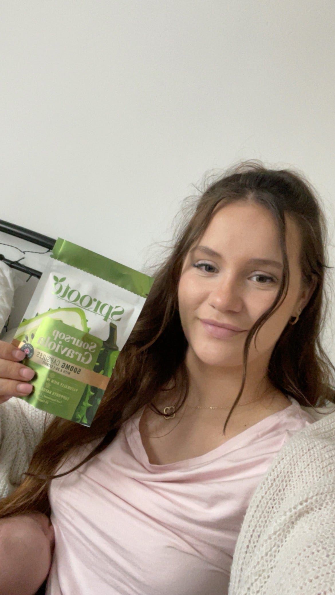 Sproote customer holding a Soursop Graviola pouch at home